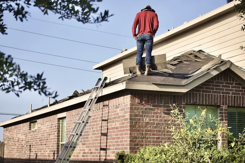 Professional roofer working on a residential roof in Underwood Corner